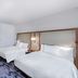 Fairfield by Marriott Inn & Suites Aberdeen, SD guest room with two beds and a wardrobe in Aberdeen