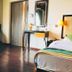 Hotel Dip Palace Darjeeling guest room with window seat, bed, vanity, and wooden floor