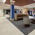 Holiday Inn Express & Suites Ventura Harbor lobby with seating area and front desk in Ventura