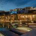 Rocabella Mykonos Hotel in Agios Stefanos with a serene pool and luxury cabanas at dusk