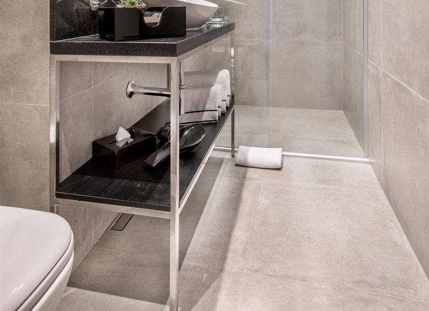 Meliá Paulista Sao Paulo bathroom with walk-in shower, vanity shelf, and contemporary tile finishes