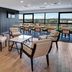 Sheraton Eatontown Hotel lounge with seating and large windows overlooking Eatontown