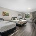 Tasman Holiday Parks - Christchurch room with two beds, dining table and large window view