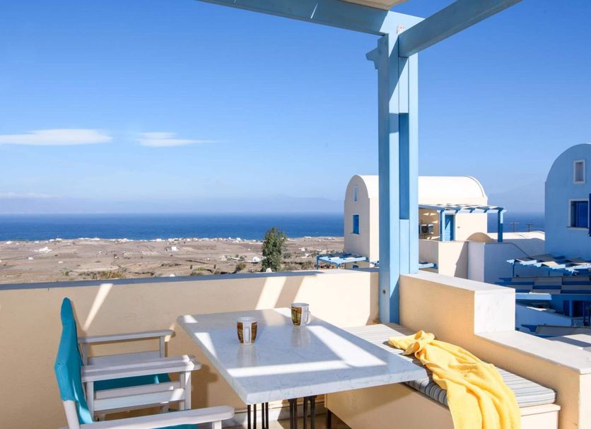 Maria's Place - Adults Only in Oia, terrace dining with sea view and white-blue Cycladic architecture