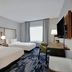 Fairfield by Marriott Inn & Suites Milwaukee Brookfield guest room with two beds, desk, chair and window
