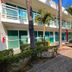 Hotel Cascada in Cuautla exterior with palm trees, walkway, and turquoise balcony railings