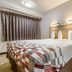 Red Roof Inn Detroit - Farmington Hills guest room with bed, nightstands and curtained window