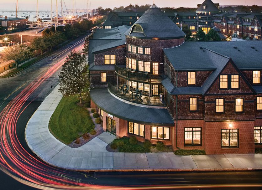 Club Wyndham Long Wharf in Newport with marina view at dusk and illuminated waterfront buildings