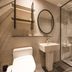 Jamsil Stay Hotel Seoul bathroom with walk-in shower, pedestal sink, toilet and wall shelves