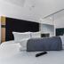 The Z Hotel Holborn in London, compact modern bedroom with king bed and glass partition