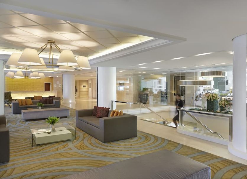Dusit Princess Srinakarin Bangkok lobby with seating area, polished floors and staircase in Bangkok