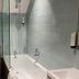 Bathroom at The Lodge At Meyrick Park in Bournemouth with bathtub, shower screen, toilet and vanity