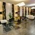 Sercotel Puerta de la Catedral in Salamanca lobby with white seating, glass tables and stone wall