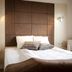 Sturup Airport Hotel in Sturup, a double bed with brown upholstered headboard and wall lights