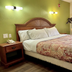 Red Carpet Inn - New Brunswick guest room with king bed, nightstand, wall lights, and window