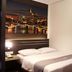 Neotel Hotel City Centre, Tanjung Redeb room with double bed and city skyline wall art