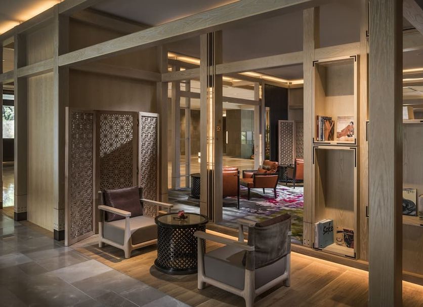 Four Seasons Hotel Kyoto lounge with armchairs, patterned screens, and warm ambient lighting
