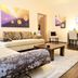 Hotel Merkur - Superior Baden-Baden lounge with sofa, coffee table, desk and wall-mounted TV