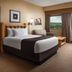 Great Wolf Lodge - Boston Fitchburg Ma guest room with bed, sitting area, and forest view