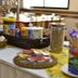 Champagnat Praia in Vila Velha buffet table with cereal, yogurt, juice, and bread baskets