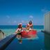 OBLU SELECT Lobigili in Malé: overwater pool deck with guests and ocean view