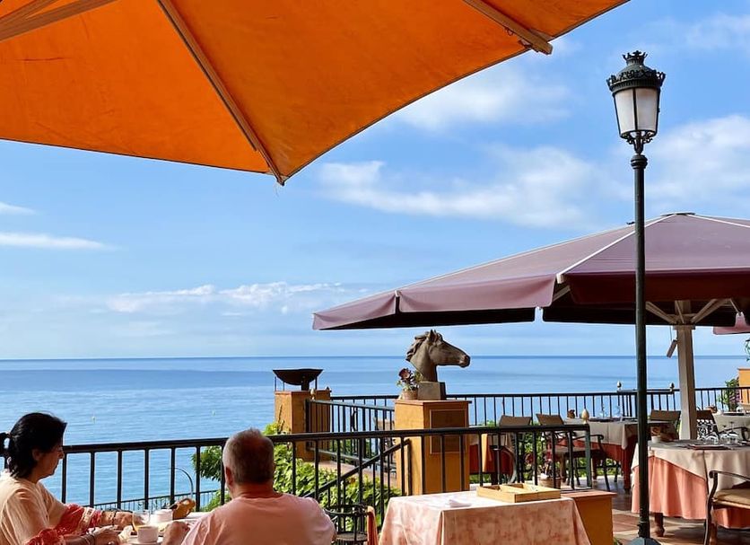 Sea-view terrace at Rigat Park & Spa Hotel in Lloret de Mar with umbrellas and ocean horizon