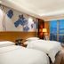Minyoun Chengdu Dongda Hotel in Chengdu guest room with twin beds and city skyline view