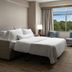 The Westin Reston Heights guest room with king bed, sitting area, and large window view in Reston