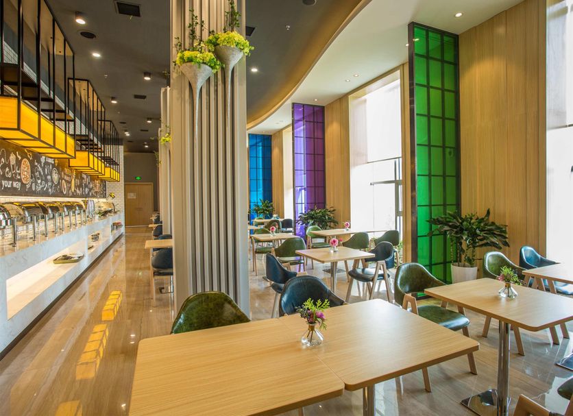 ibis Styles Changsha Intl Exhibition Ctr dining area with colorful stained-glass windows in Changsha