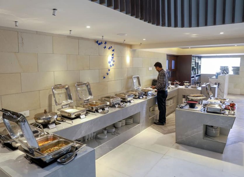 Royal Orchid Golden Suites Pune breakfast buffet setup in a modern dining area