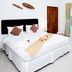 Nadivana Serviced Apartment in Krabi, bright bedroom with balcony and poolside view