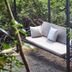 Villa Rock Stop Falls Gigiri in Nairobi with a hanging outdoor sofa amid lush greenery