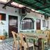 Hotel Ajay International, Agra: covered outdoor dining area with tables and plastic chairs