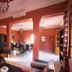 La Maison des Oliviers in Marrakech: warm lounge with fireplace, columns, and dining area