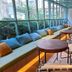 Via Hotel Zhongli lounge seating area with large windows and wooden tables in Taoyuan City