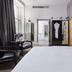 Titanic Hotel Belfast guest room in Belfast with bed, seating area, and wardrobe