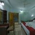 Blooming Paradise Thekkady guest room with double bed, desk, chair, and balcony door