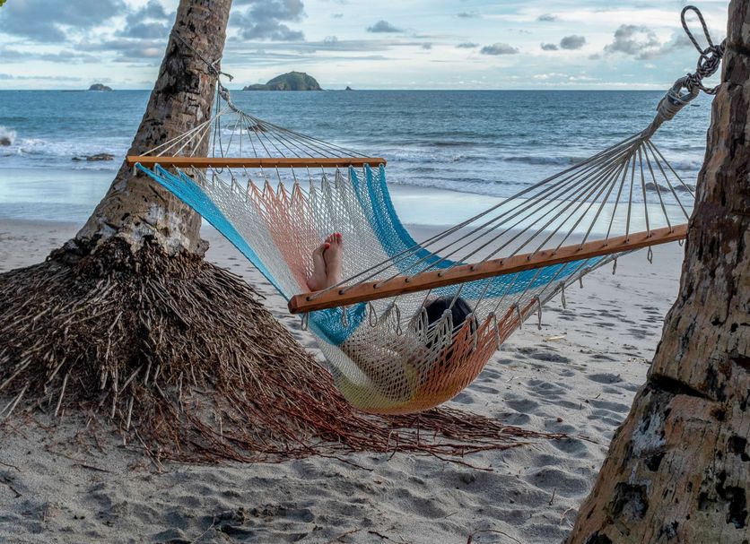 Arenas del Mar Beachfront & Rainforest Resort in Manuel Antonio, beach hammock between palm trees by the ocean