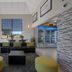 Hotel 28 Boise Airport, an Ascend Collection Hotel lobby seating area with lounge chairs and fridge in Boise