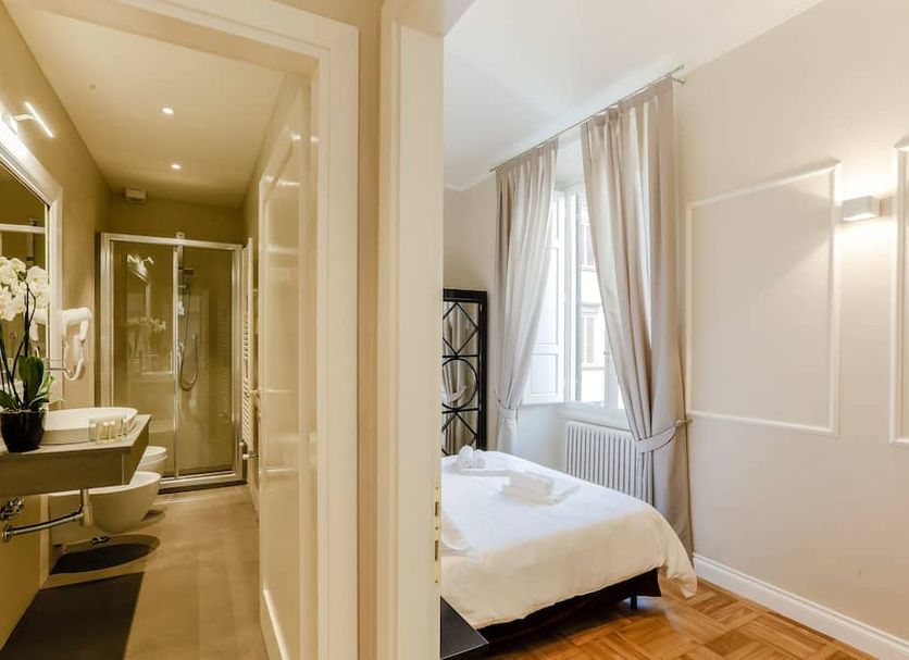 Relais Tosinghi Florence hotel room and en-suite bathroom with walk-in shower, sink, and large window