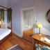 Pêche De Vigne & Spa in Rodern: canopy bed with forest view, wooden floor, and bedside lamp