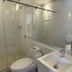 Casa Hotel Boyaca Real Bogotá bathroom with glass shower, vanity sink, and toilet