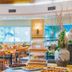 Ein Gedi Kibbutz Hotel in En Gedi dining room with buffet, wooden tables, and large windows