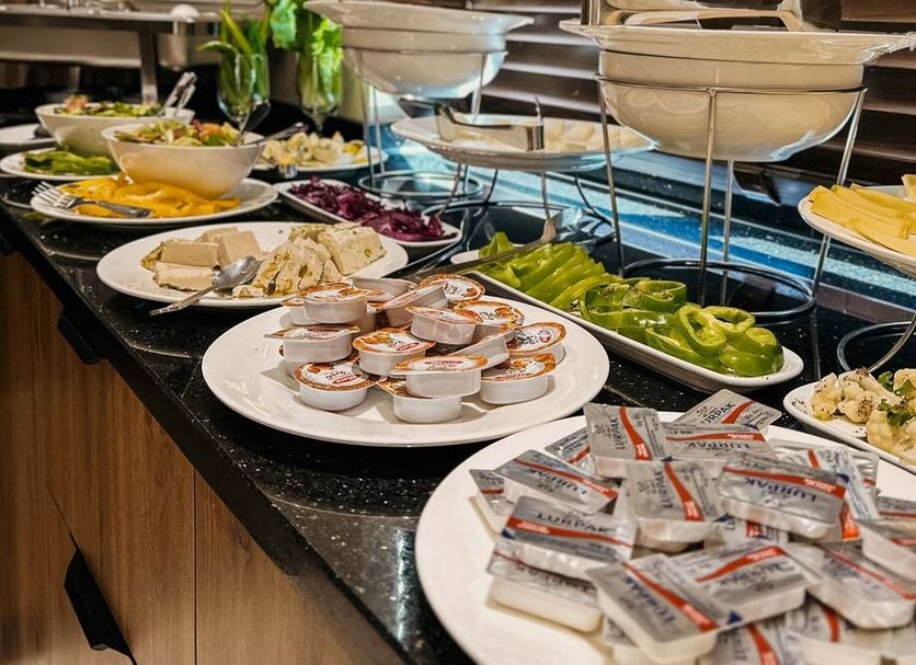 Celino Hotel Amman breakfast buffet with fruit, eggs, cheese, yogurt and salad on a counter