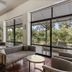 Calamos Beach Family Club in Agii Apostoli lobby lounge with seating and large windows overlooking greenery