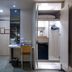 East Dragon Hotel Taipei City room with desk, open wardrobe, and frosted glass bathroom door