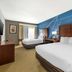 Comfort Suites Omaha East-Council Bluffs room with two beds and blue accent wall in Council Bluffs