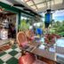 Hale Kawehi Bnb Guesthouse in Hilo: covered patio with woven chairs, dining table, and garden view