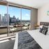 Aura on Flinders Serviced Apartments, Melbourne: bedroom with balcony and city skyline view