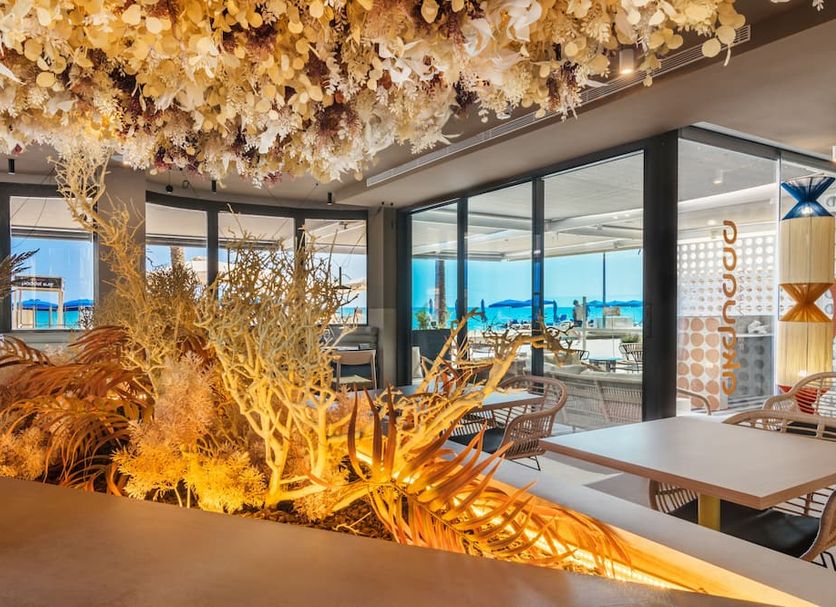 Akquaaa Boutique Hotel in Calafell lounge with floral ceiling and sea-view windows